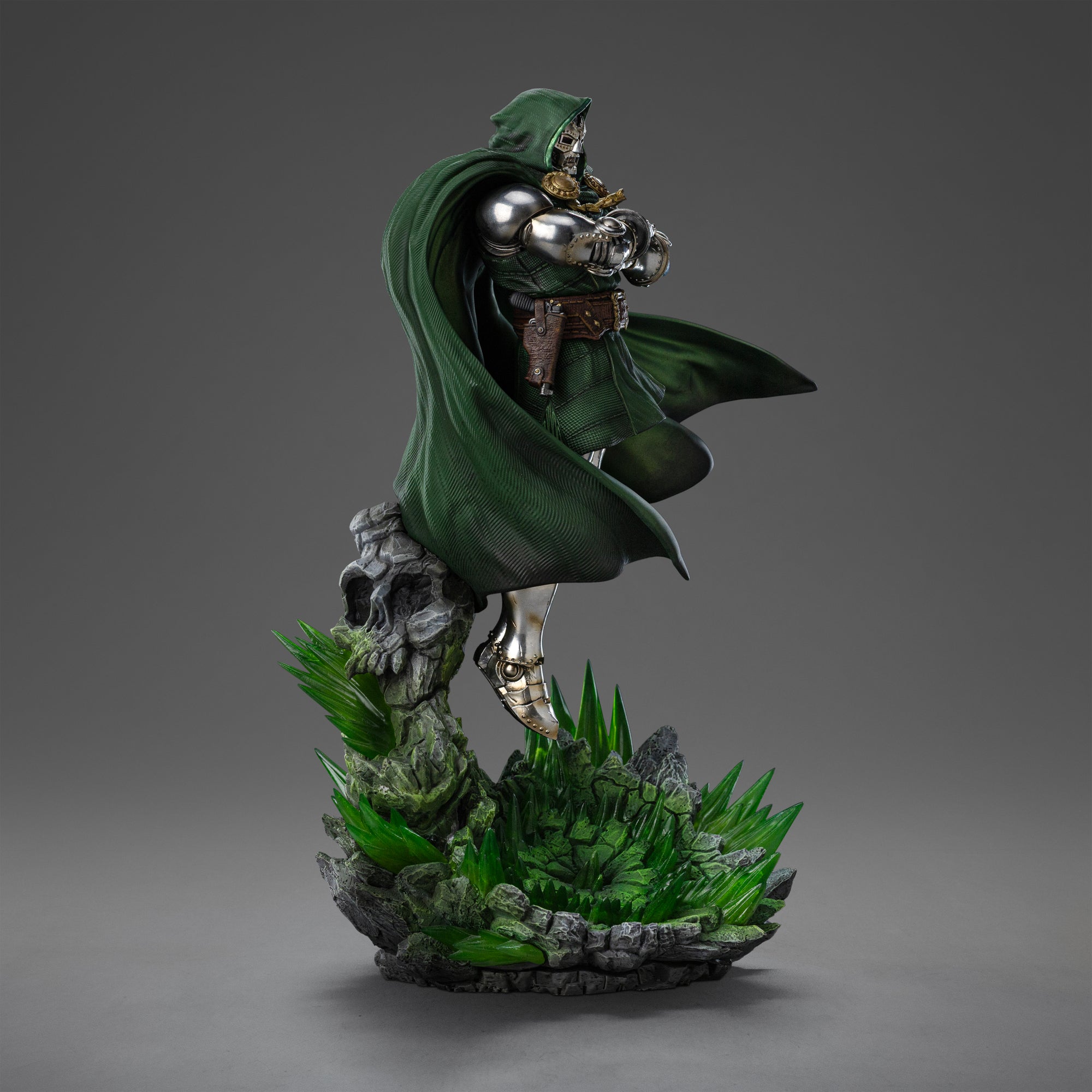 Left view of the Doctor Doom 1/10 Scale Statue, highlighting his classic metal mask, green cloak, and arms crossed over his chest.