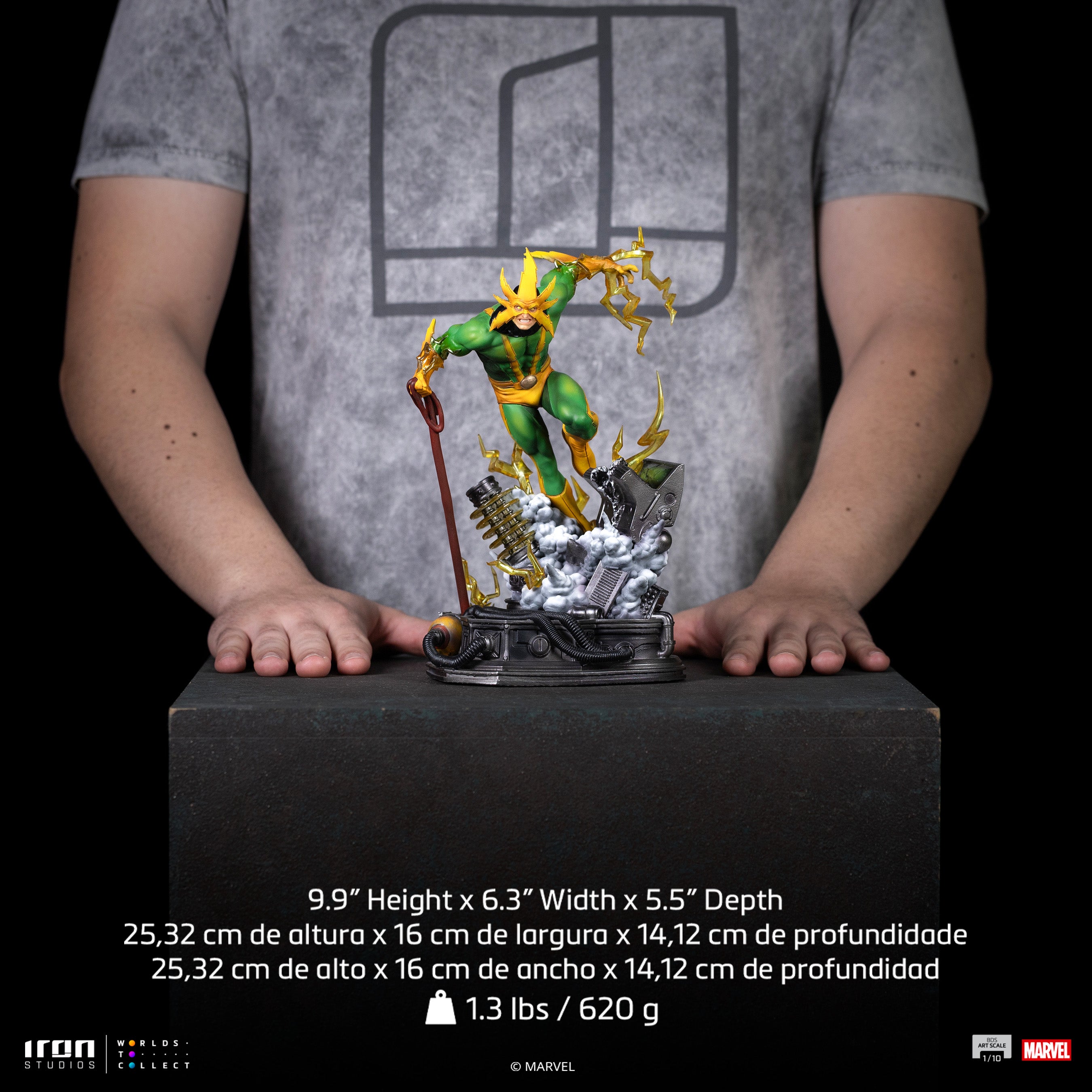 A size comparison photo of the Iron Studios Electro 1/10 Scale Statue held by hands, with its 9.9-inch height, 6.3-inch width and 5.5-inch depth dimensions listed.