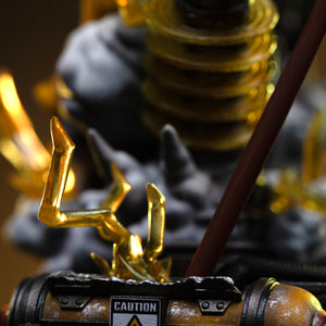 A close-up of the industrial diorama base, showing a caution sign reading "HIGH VOLTAGE" next to a glowing lightning effect.