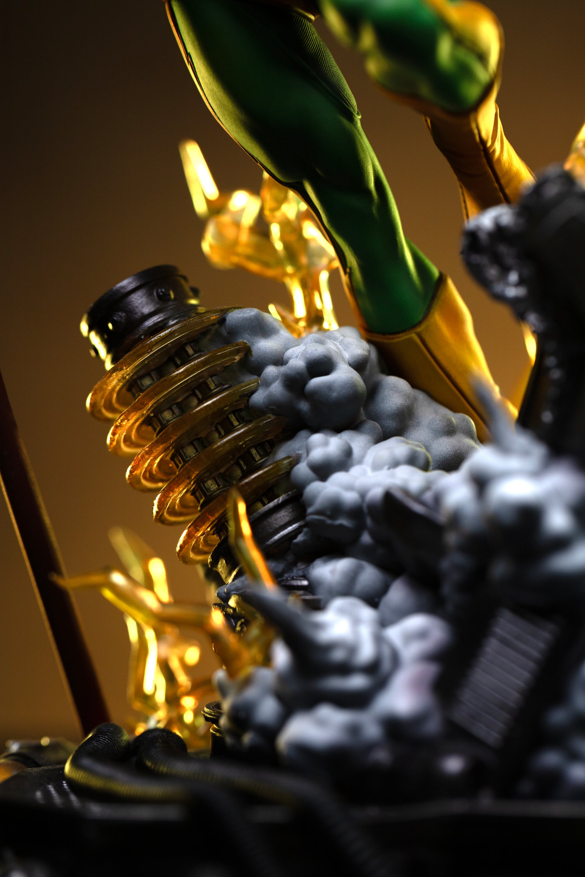 A close-up of the diorama base, highlighting a detailed metallic coil component next to the sculpted smoke effects.