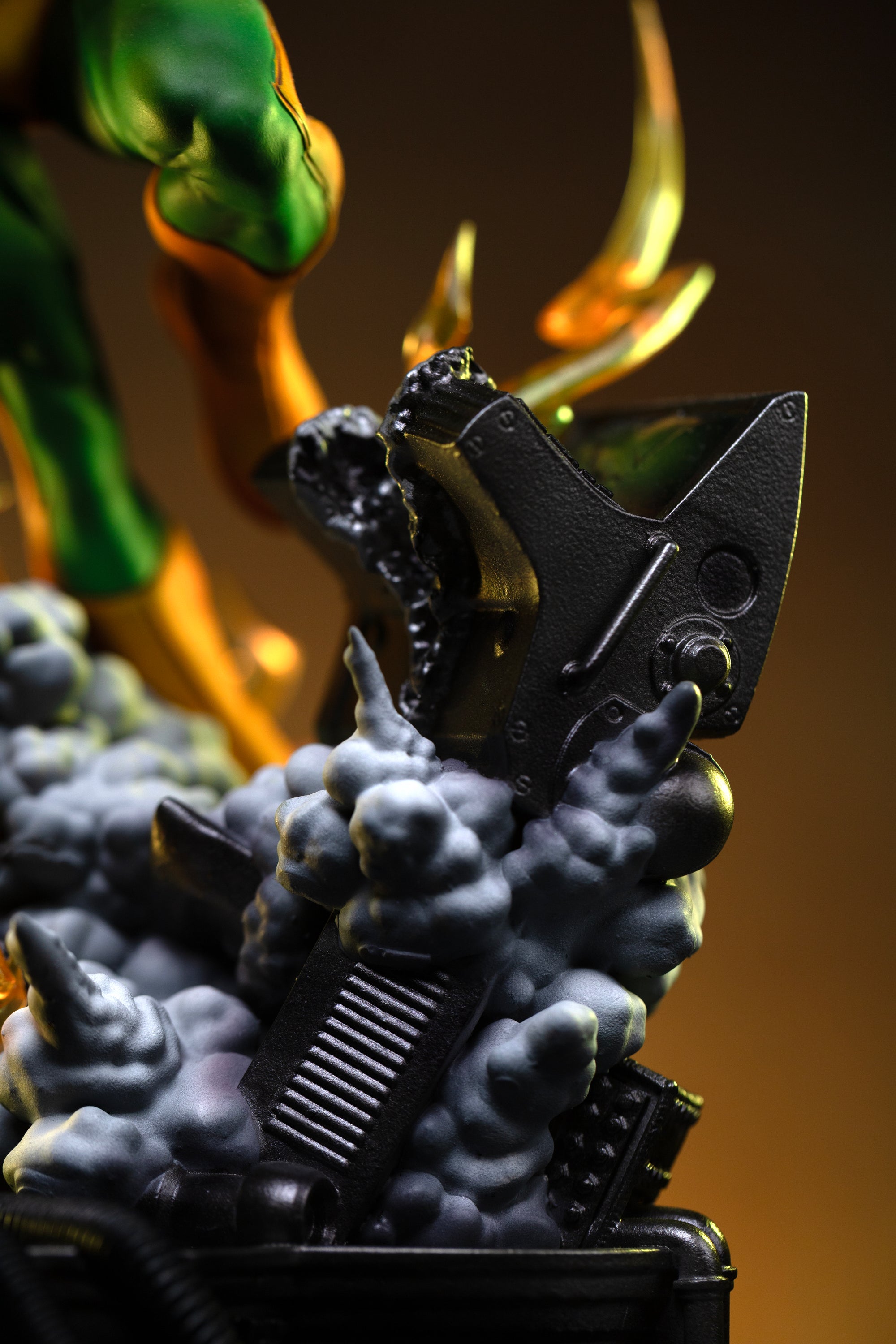 A detailed close-up of the industrial diorama base, showing metallic wreckage surrounded by sculpted white smoke and lightning.