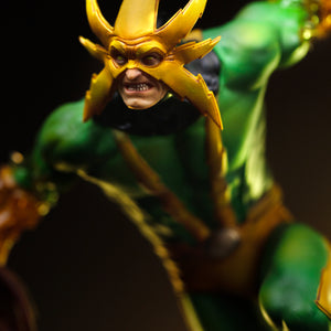 A close-up of the Electro statue's upper body, highlighting the detail on his mask and the texture of his green and yellow suit.
