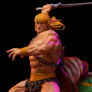 Close-up side view of He-Man from the Iron Studios statue, showing his detailed musculature, golden hair, and raised arm holding the Power Sword.