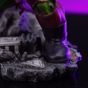 Close-up of Hulk's black boot and lower leg, resting on the detailed, cracked stone diorama base.