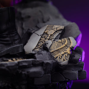 A close-up of the Hulk Deluxe diorama base, showing Hulk's boot next to a piece of destroyed gold armor or technology.