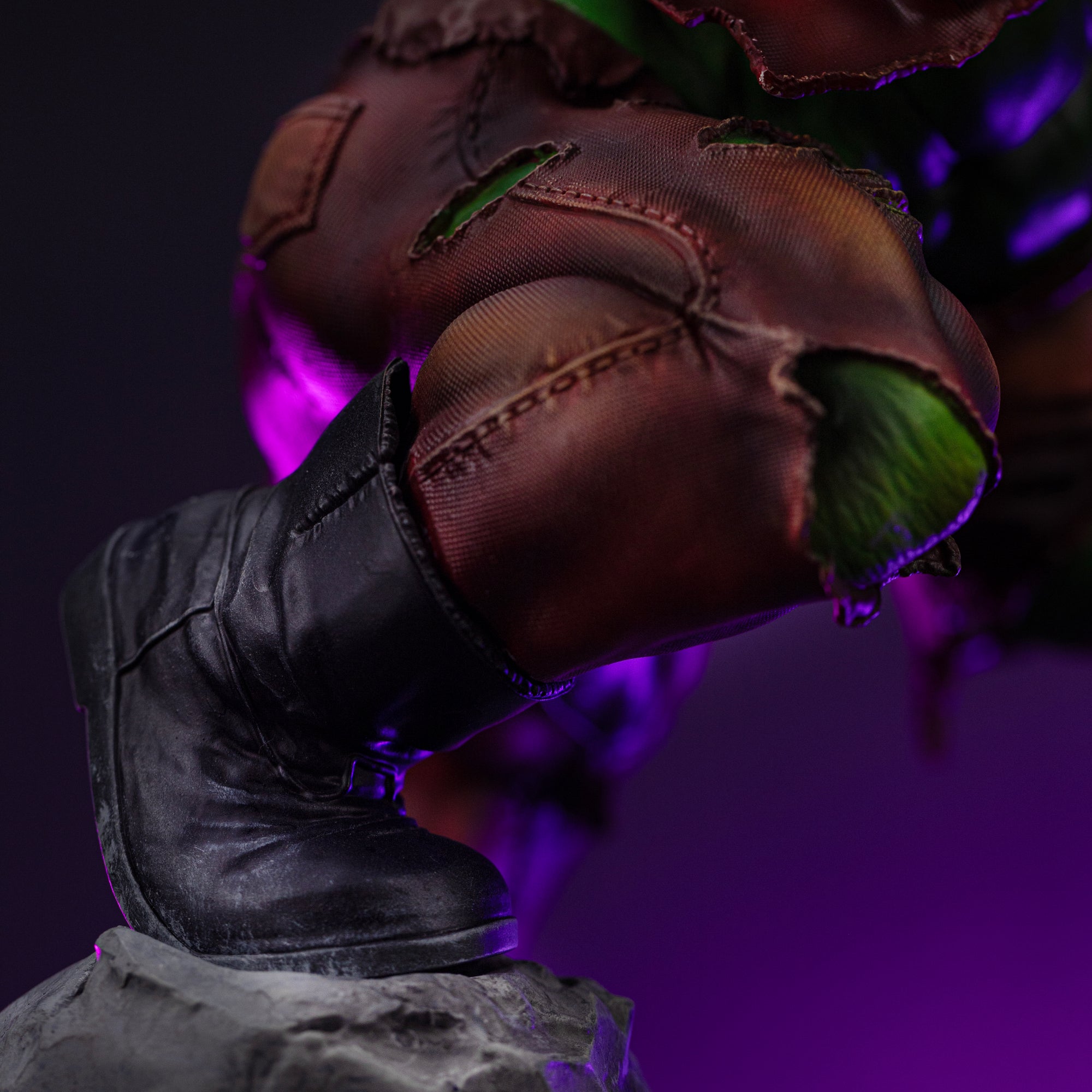 A close-up of Hulk's boot and knee, highlighting the detailed sculpt of the torn brown pants and the muscle showing through.