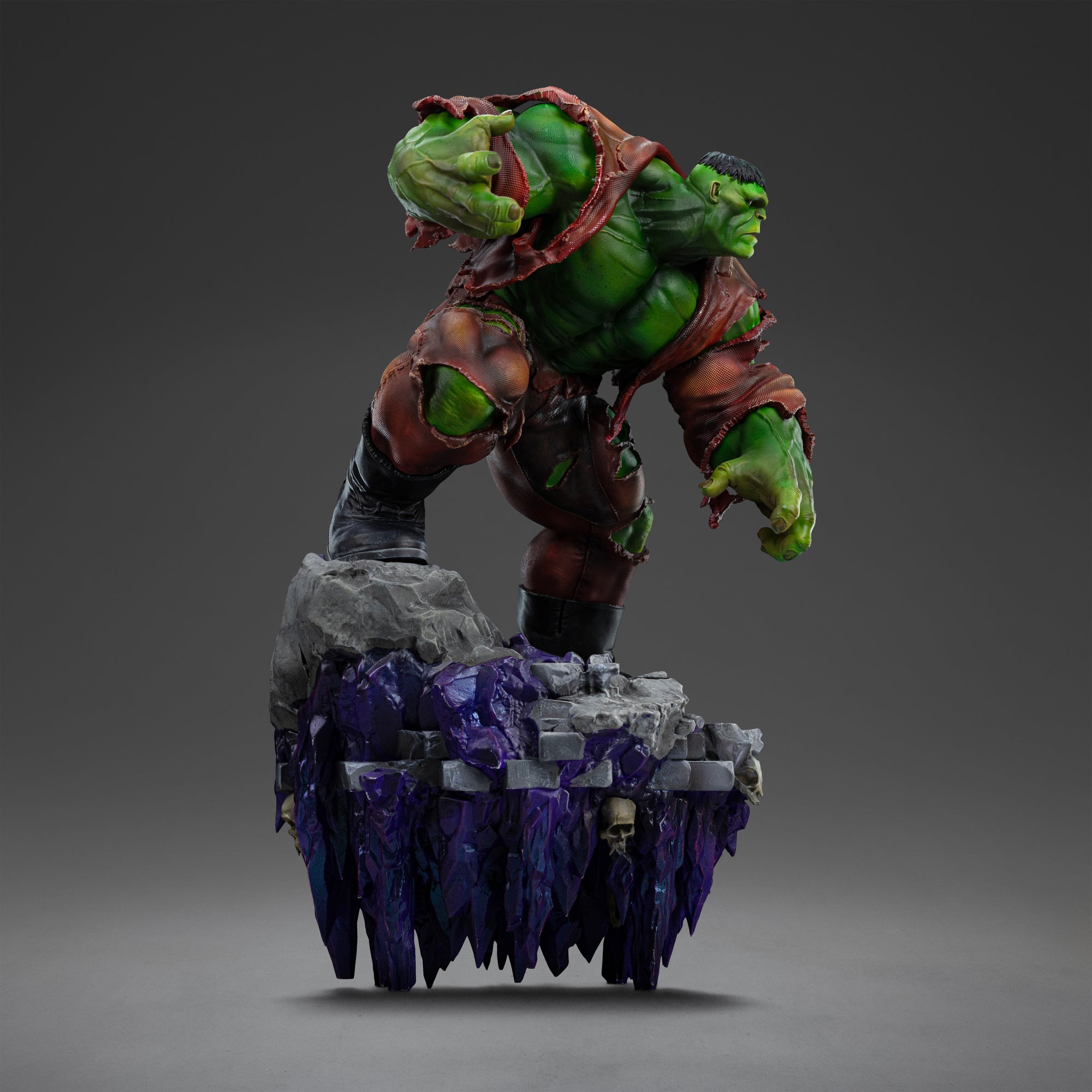 A left profile view of the Hulk Deluxe statue, highlighting his massive green form and the unique, elongated purple crystal base below the rocky platform.