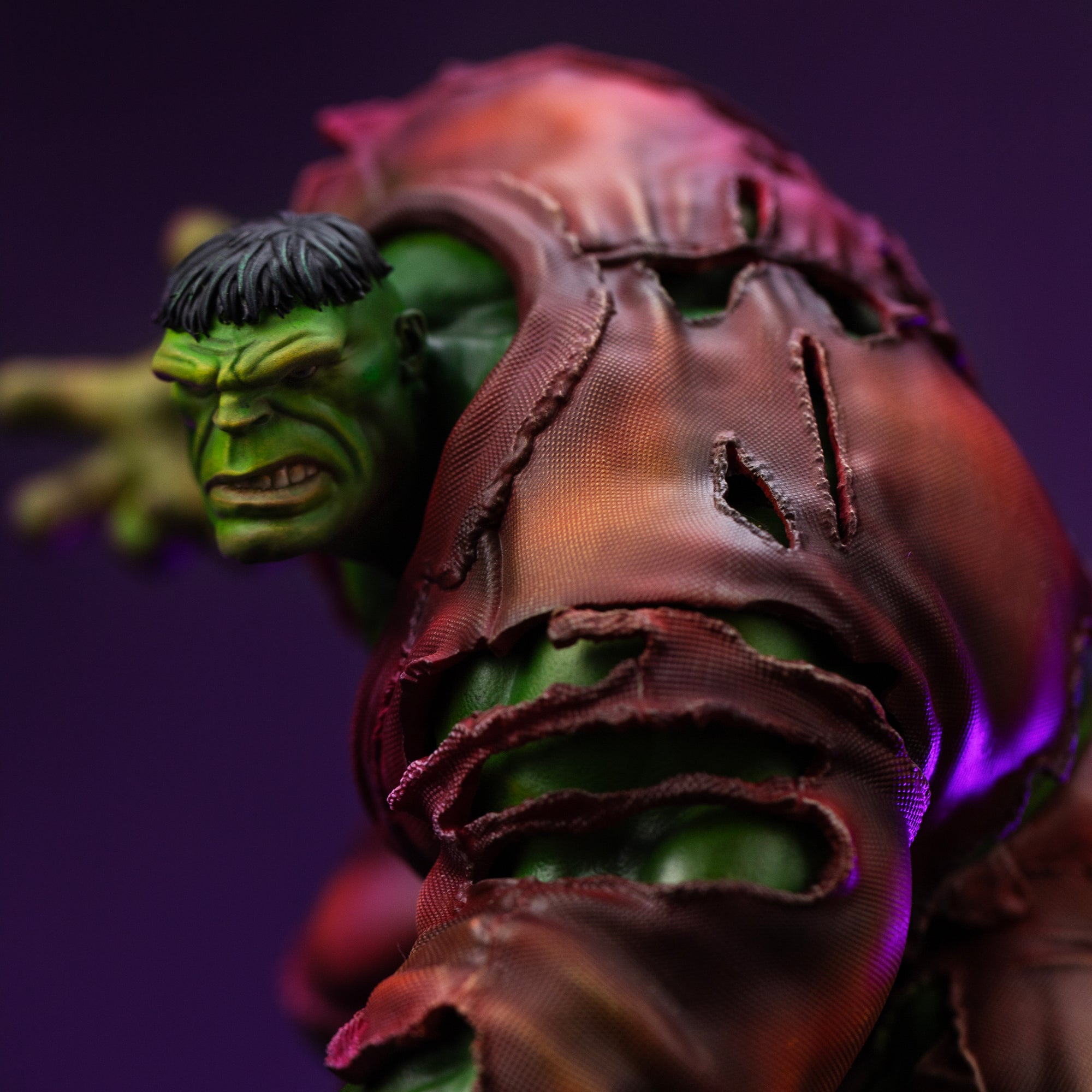 Close-up view of the Hulk's back, emphasizing the highly detailed texture and rips in his brown shirt, exposing his green skin.