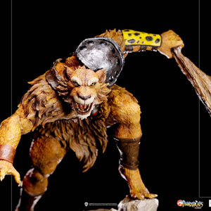 A detailed close-up of the Jackalman statue, focusing on his snarling expression, snarling teeth, and the iconic yellow arm guard with black spots.