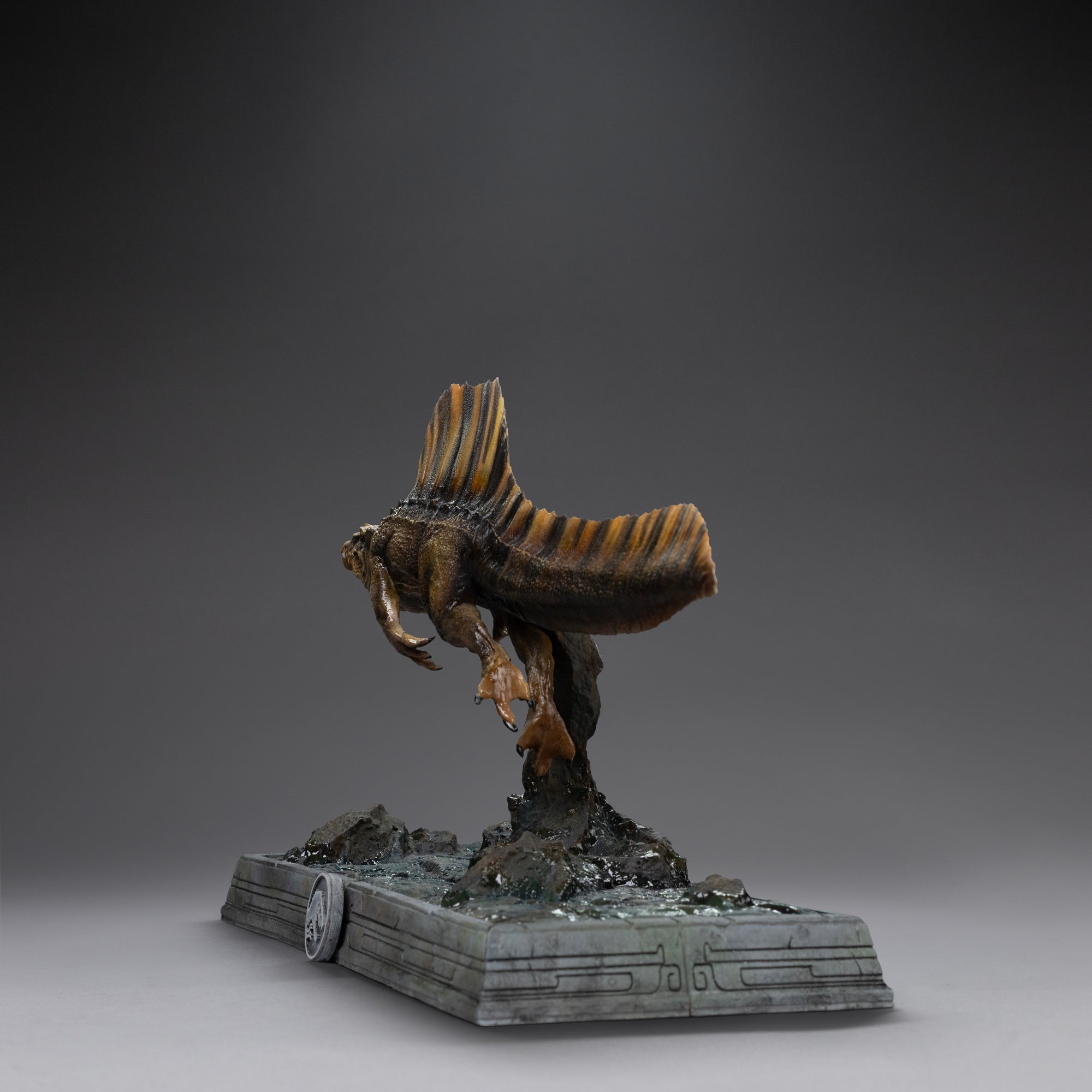 Rear view of Iron Studios Jurassic World Rebirth Icons Spinosaurus statue showing tail and dorsal sail