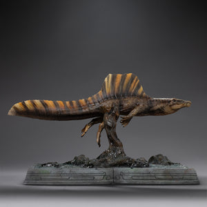 Right side profile of Iron Studios Spinosaurus statue showing striped sail pattern and aquatic base