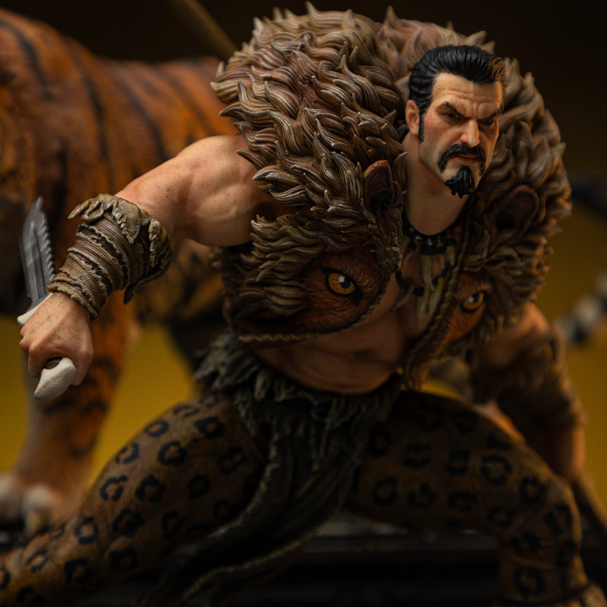 Close-up of Kraven the Hunter's face and upper body, showing his stern expression, dagger, and the detailed fur collar of his outfit.