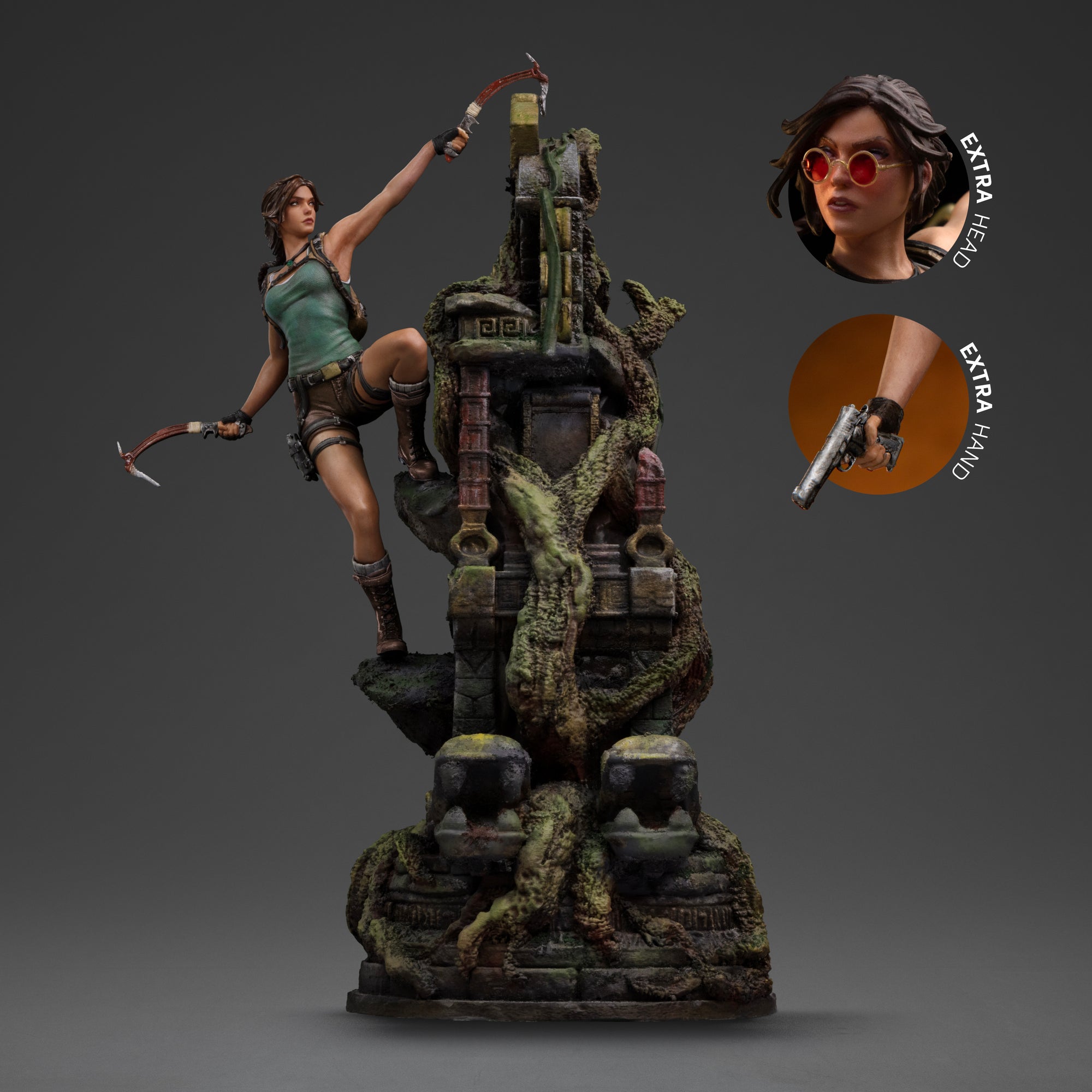 The Lara Croft Deluxe Art Scale 1/10 statue shown with callouts for the interchangeable head (no sunglasses) and hand (pistol) accessories.