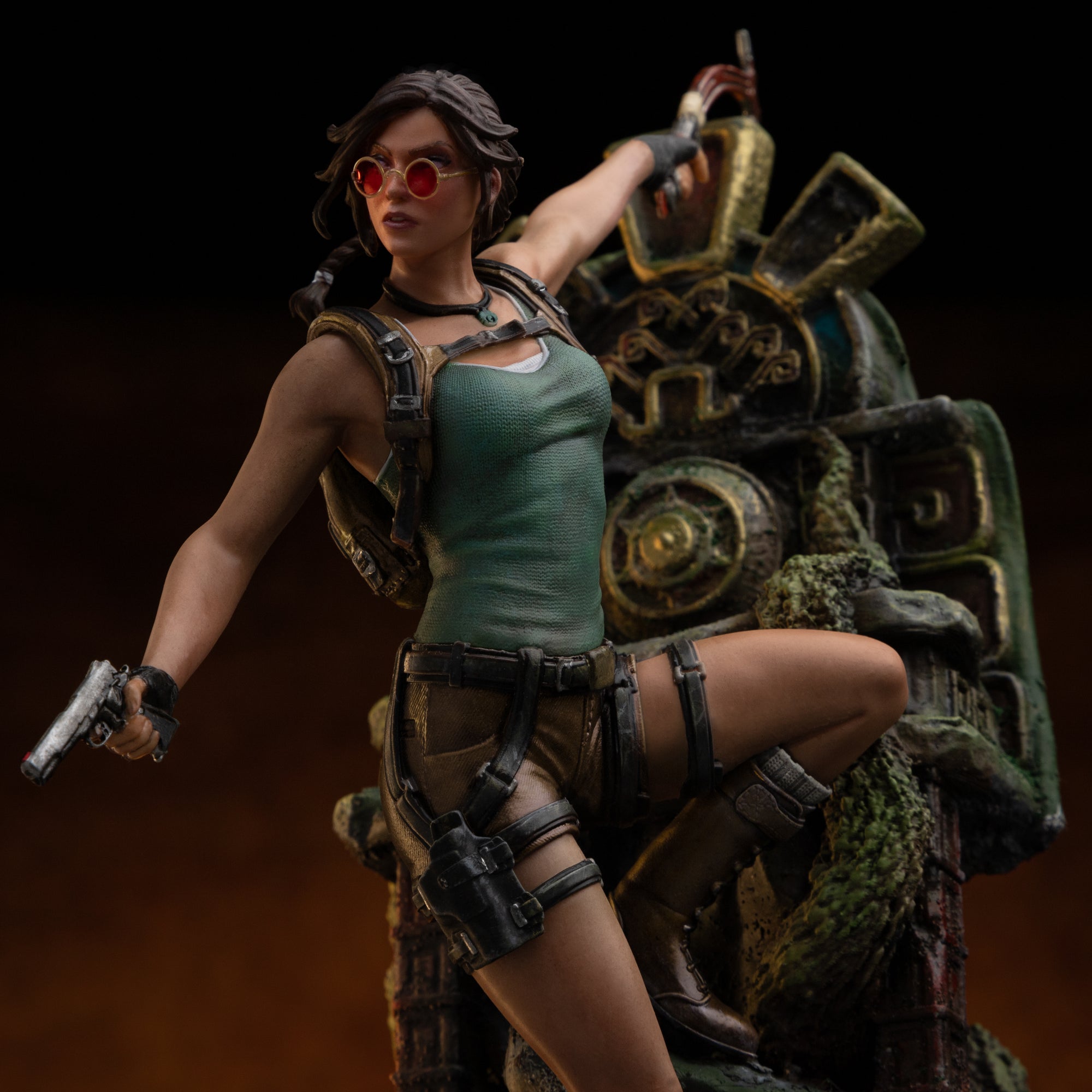 A mid-range close-up of the Lara Croft statue, highlighting her red sunglasses, tank top, and the pistol holstered on her thigh rig.