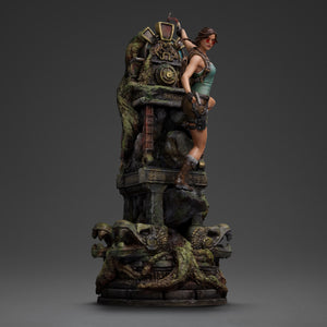 Side view of the Iron Studios Lara Croft statue with sunglasses and pistol, emphasizing the full 14.1-inch height of the ancient ruin diorama base.