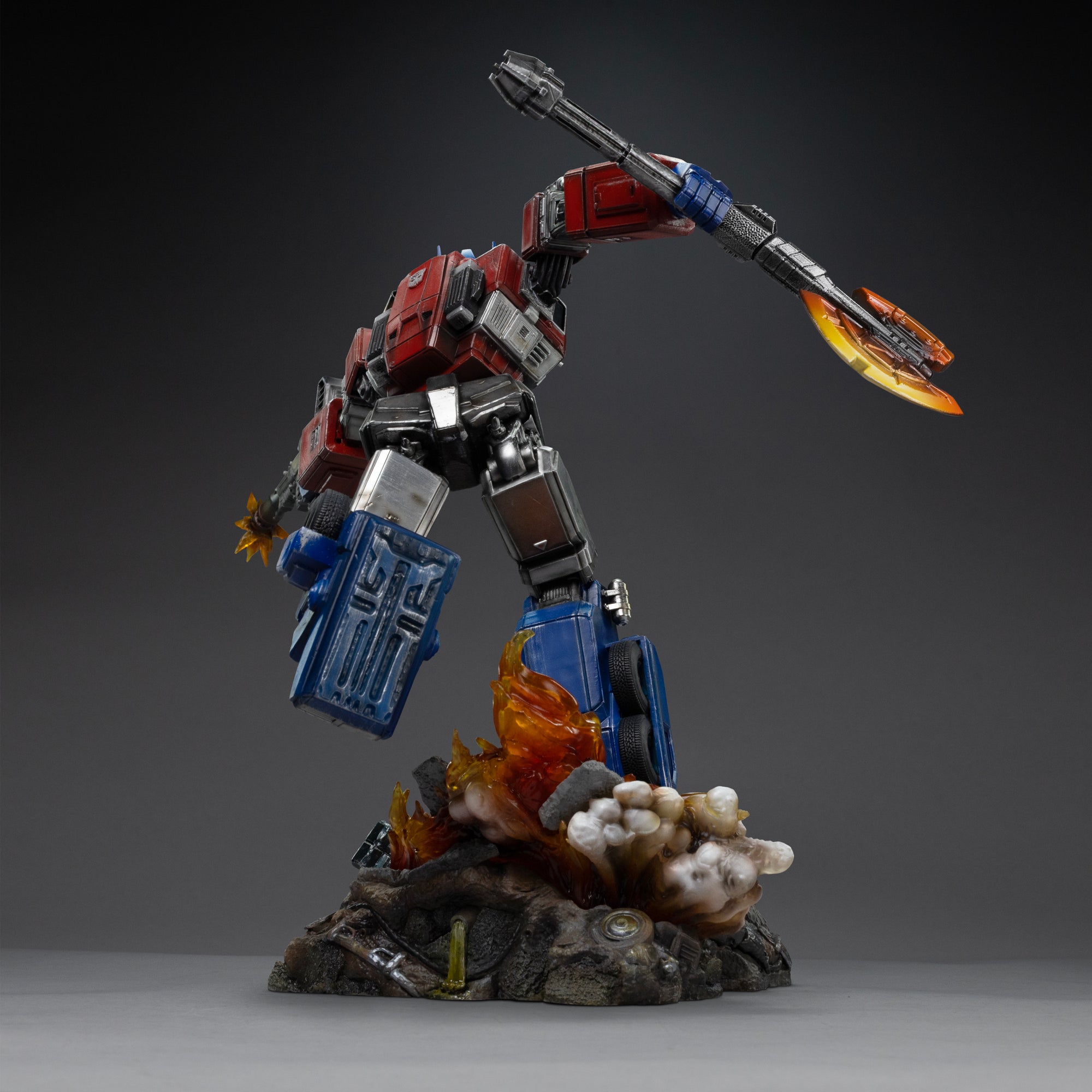 Rear view of the Iron Studios Optimus Prime statue showcasing mechanical armor details and flaming diorama base.