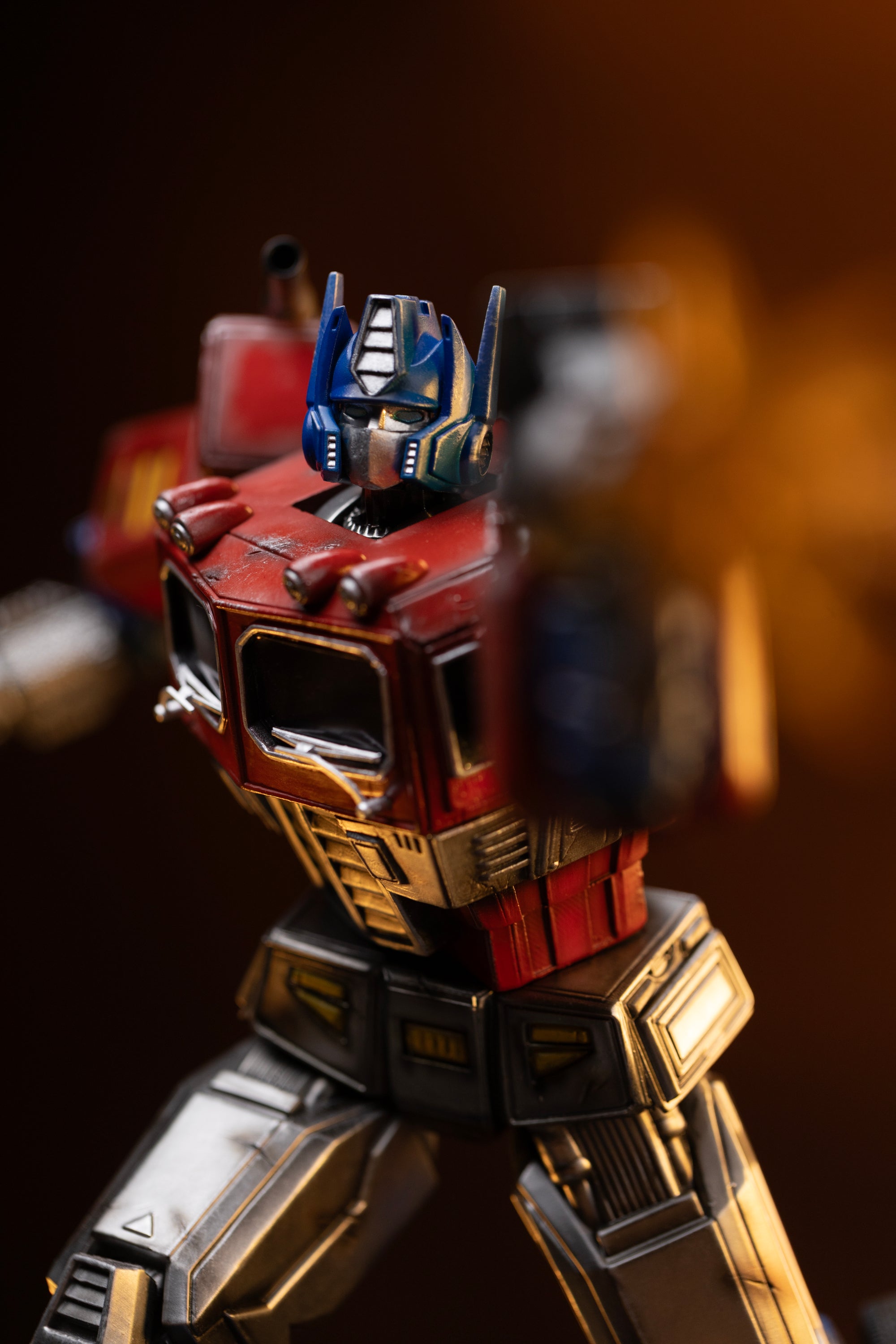 Close-up of the painted truck cab chest, headlights, and waist articulation on the Iron Studios Optimus Prime statue.
