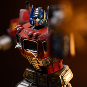 Close-up of the painted truck cab chest, headlights, and waist articulation on the Iron Studios Optimus Prime statue.