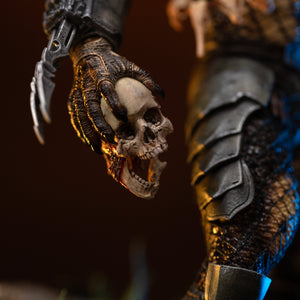 Detail close-up of Iron Studios 1/10 Predator Jungle Hunter alternate arm holding a severed human skull