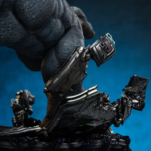 Close-up of Rhino's lower leg and foot, highlighting the damaged armor and the destroyed tech elements on the diorama base.