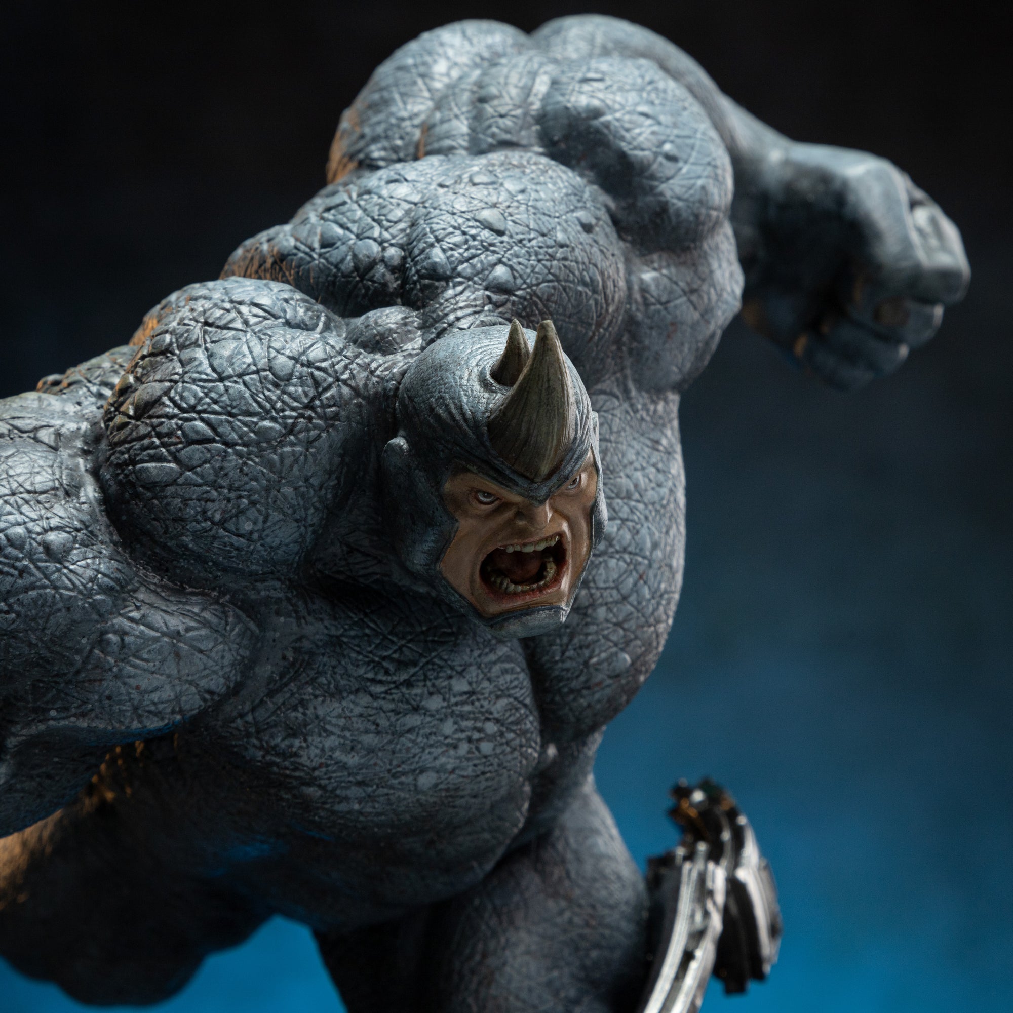 A detailed close-up of Rhino's head and upper body, showing his angry face, horn, and the textured, thick armor suit.