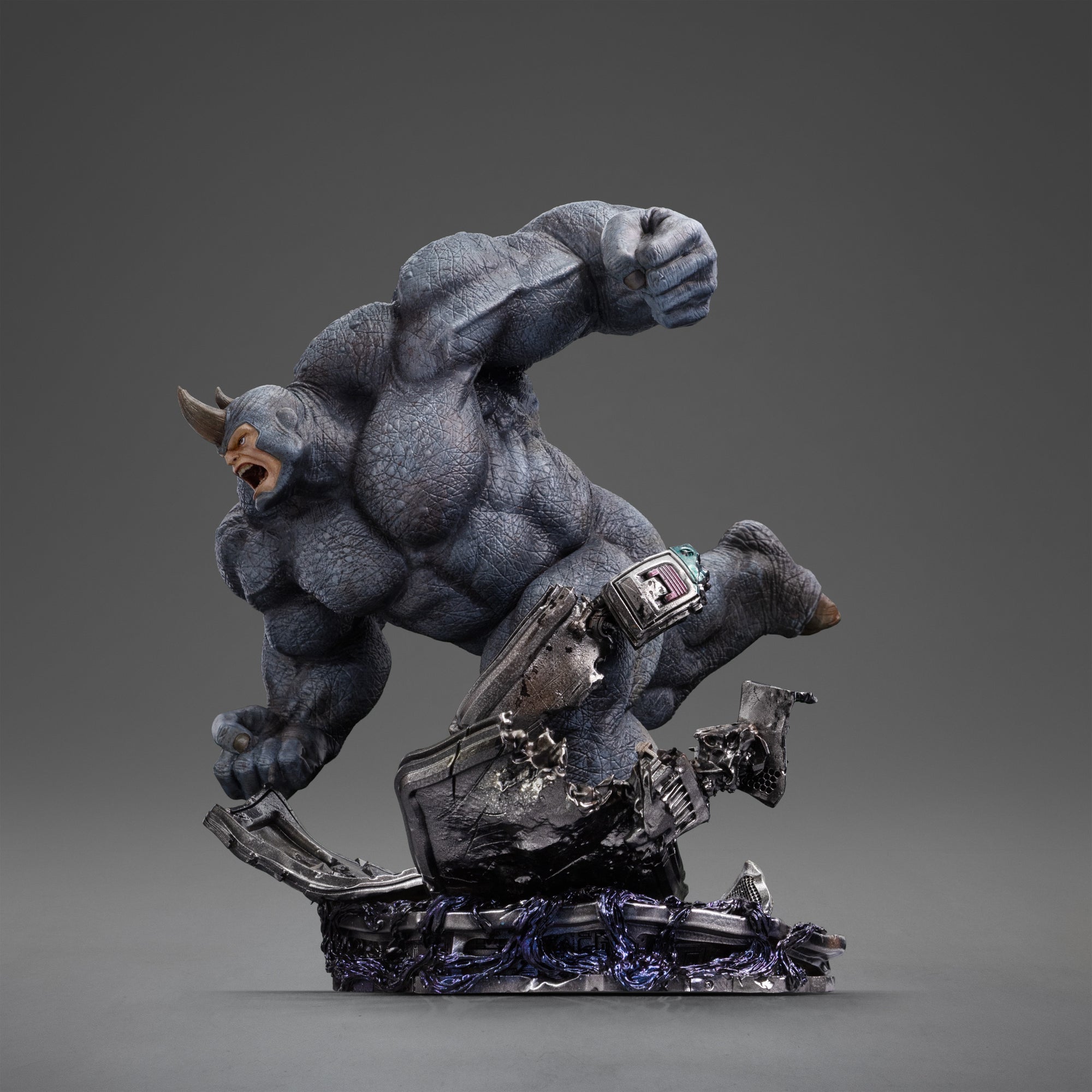 Side profile of the Rhino statue, emphasizing his powerful charging pose and the wreckage of the base.