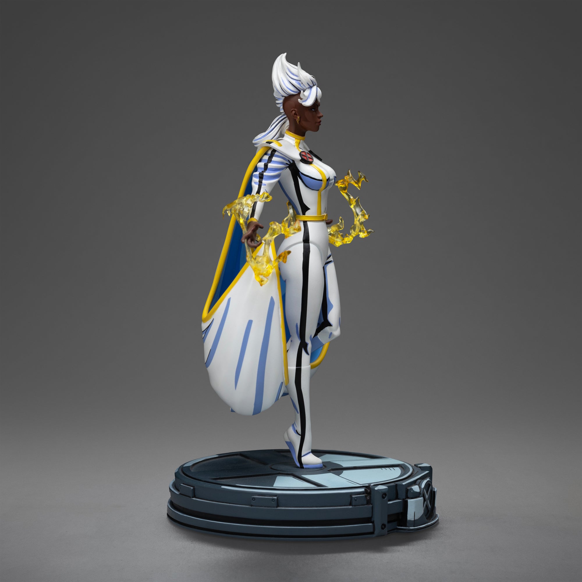 Right side profile of the Storm statue, emphasizing the cel-shaded paint finish and the dynamic sculpt of her billowing white cape.