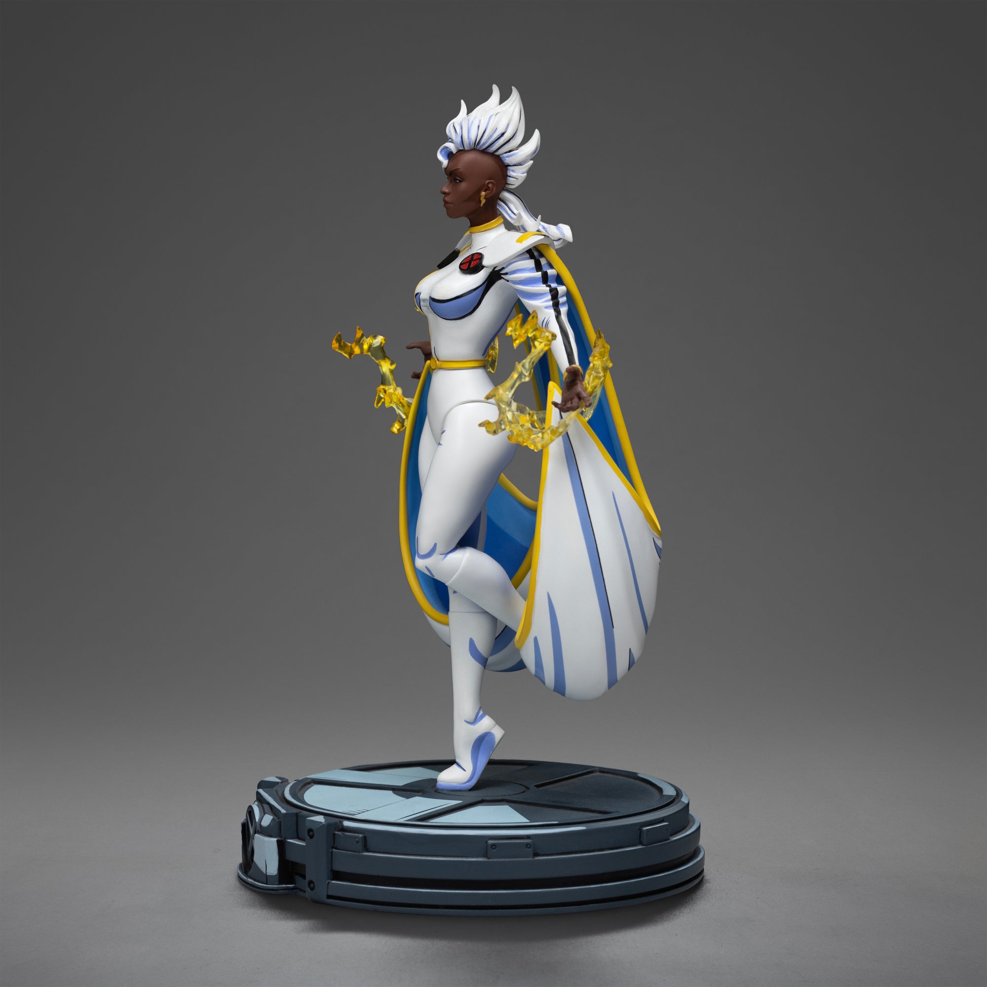 Side profile of the Storm statue, highlighting her white, blue, and yellow costume, mohawk haircut, and the translucent yellow lightning effects.