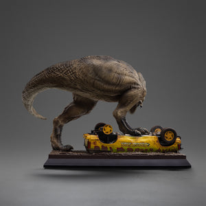 Rear view of the Iron Studios 1/10 scale Jurassic Park T-Rex Attack collectible statue, highlighting the muscle definition, skin folds, and detailed painting of the dinosaur's back and tail.
