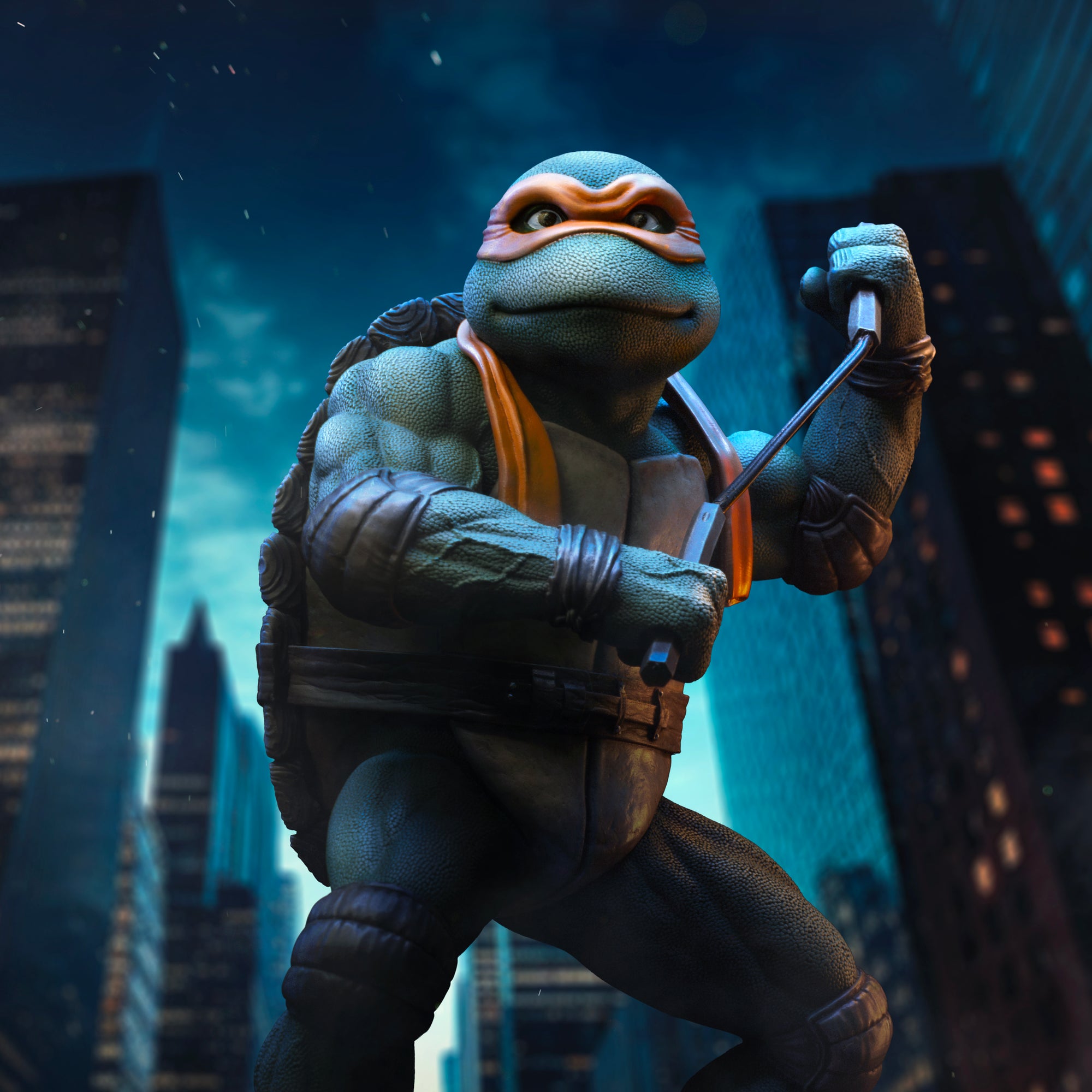 Cinematic promo graphic showing the Iron Studios TMNT 1990 Michelangelo statue posed with nunchaku against a nighttime NYC skyline.