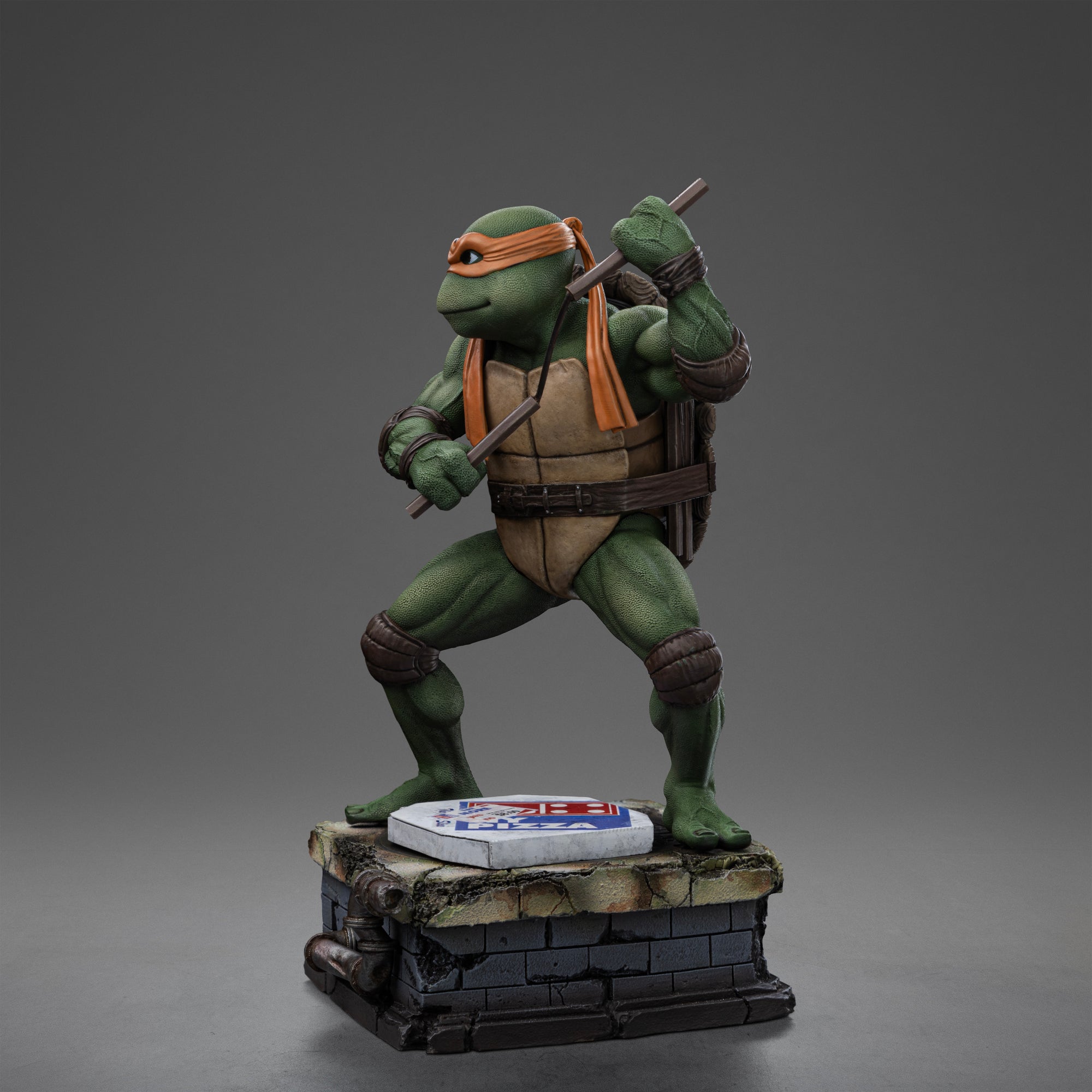 Full left profile view of the Iron Studios TMNT 1990 Michelangelo 1/10 Art Scale collectible statue ready for battle.