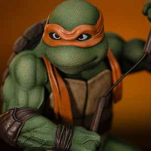 Detailed close-up portrait of Michelangelo's smiling face sculpt, orange eye mask, brown eyes, and textured green skin.