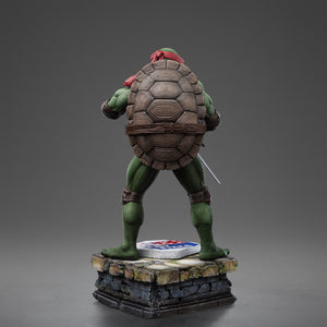 Full rear view of the Iron Studios TMNT 1990 Movie Raphael 1/10 scale polystone statue on a sewer pipe diorama base.