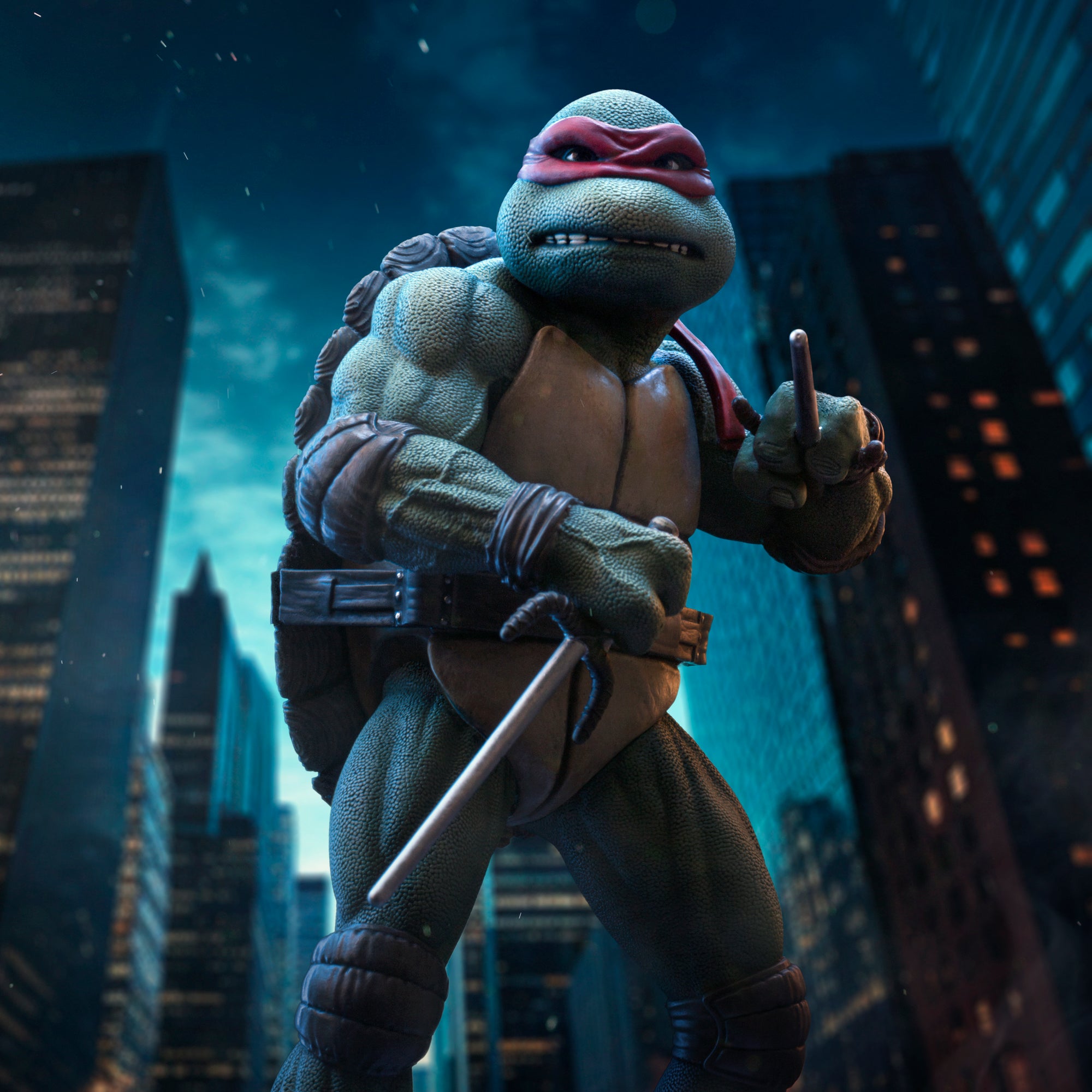 Cinematic artwork of the Iron Studios TMNT 1990 Raphael 1/10 scale statue posed with sai daggers against a nighttime New York City skyline.