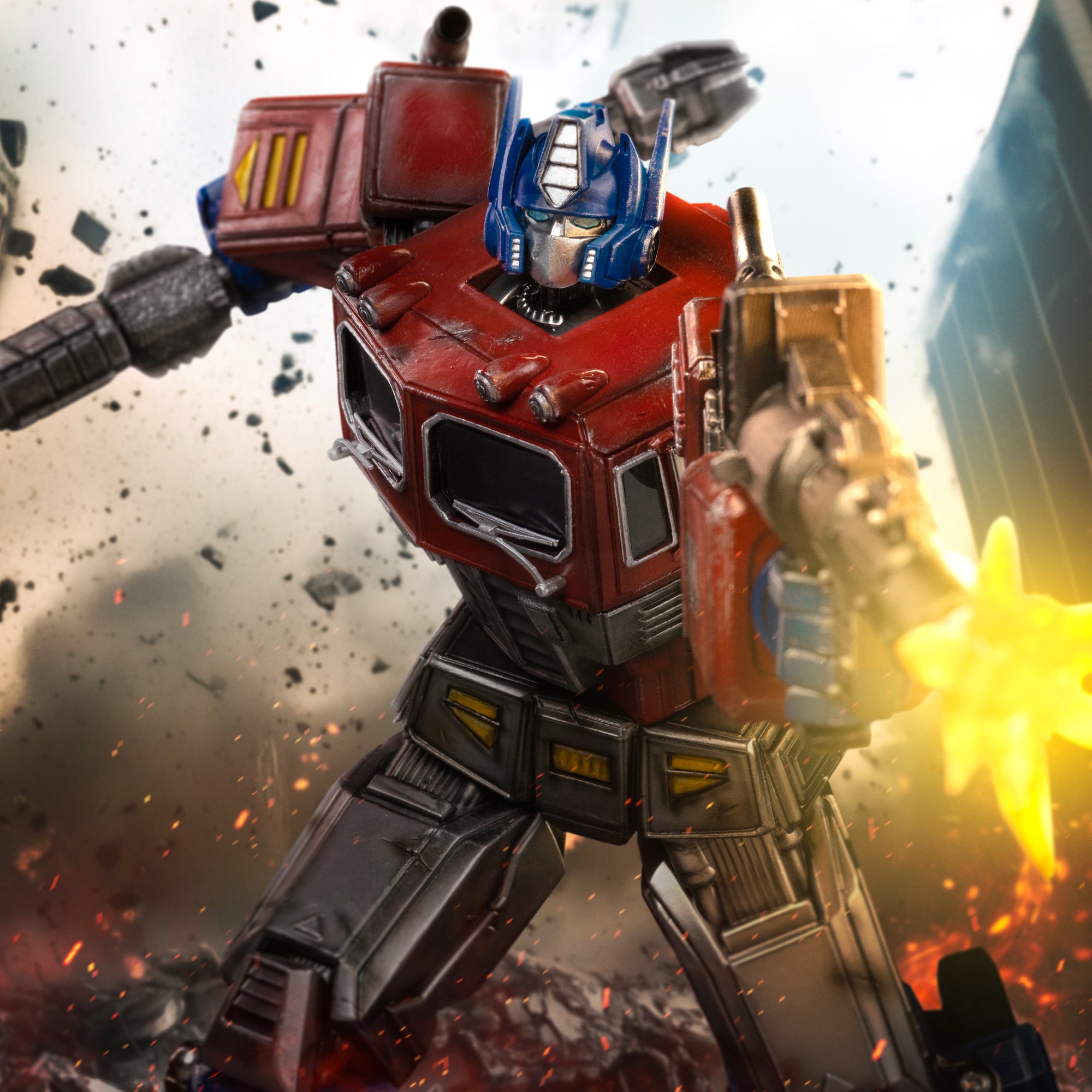 Cinematic action graphic of the Iron Studios Optimus Prime statue firing his blaster amid battlefield smoke and sparks.