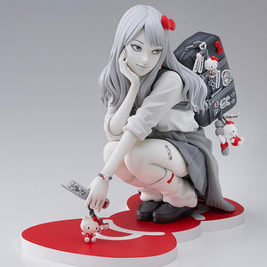 Three-quarter studio view of the Gyaru Tomie x Hello Kitty scale figure highlighting her screentone skirt, loose socks, and decorated flip phone.