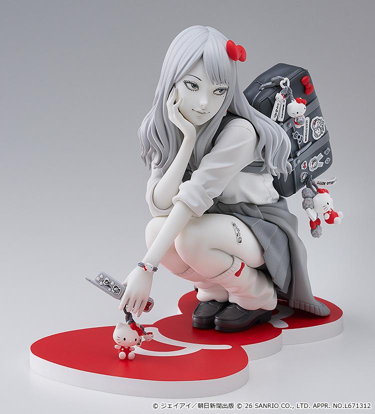 Three-quarter studio view of the Gyaru Tomie x Hello Kitty scale figure highlighting her screentone skirt, loose socks, and decorated flip phone.