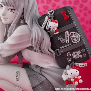 Macro close-up of the intricately detailed school bag with Hello Kitty stickers, plush charms, and the Hello Kitty tattoo sticker on Tomie's leg.