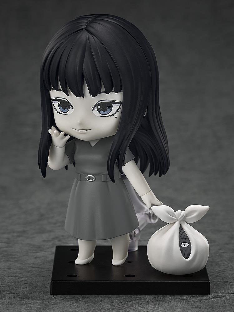 Tomie Nendoroid figure waving and holding the creepy plastic bag accessory with a hidden eye.