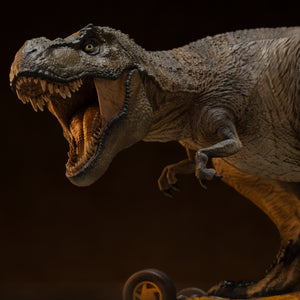 Close-up macro portrait of the roaring T-Rex head sculpt from the Iron Studios statue, displaying sharp hand-painted teeth, a wet tongue texture, and fierce yellow eyes.