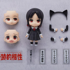 Flat lay knolling shot of the Kaguya-sama: Love is War Kaguya Shinomiya Nendoroid box contents, including interchangeable face plates, a cat ears headband, alternate arms, a flip phone, and various Japanese anime scene text plates.