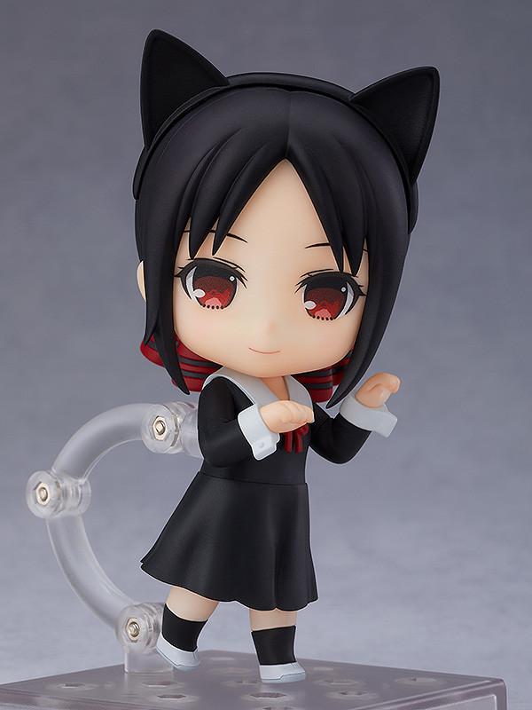 Kaguya Shinomiya Nendoroid chibi figure wearing a black cat ears headband and posing with curled hands mimicking a cat against a grey background.