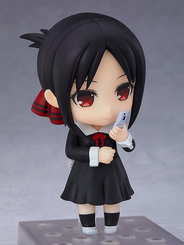 Front view of the Kaguya Shinomiya Nendoroid anime figure holding her white flip phone accessory while showing a gentle, standard smiling face plate.