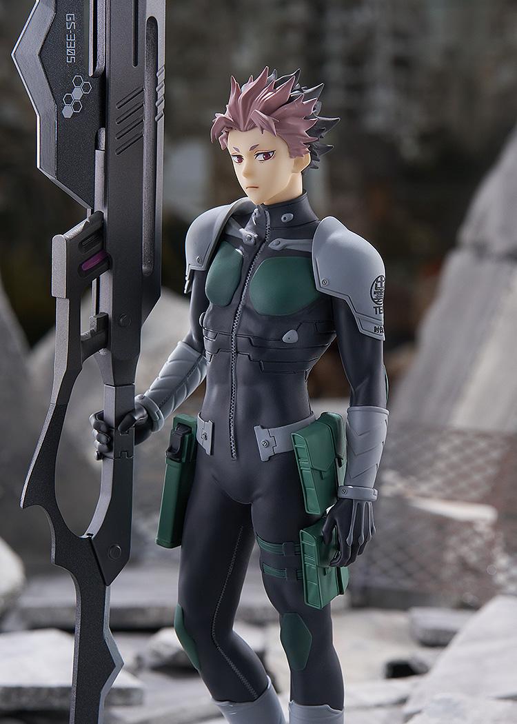 Medium close-up shot of the Gen Narumi anime figure positioned in a ruined urban battlefield setting, emphasizing the detailed tactical suit.