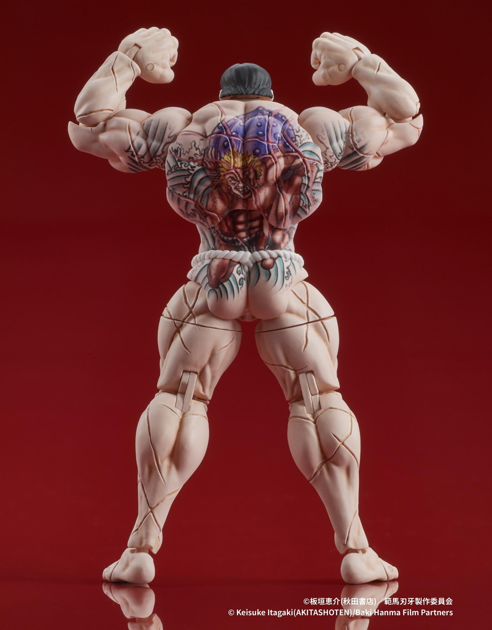 Flexing back pose showing the detailed tattoo application on the Digism figure.