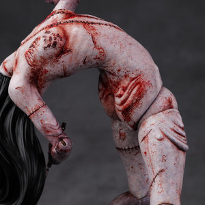 Close-up of the side torso of the Kashimashi figure, highlighting the realistic skin textures and bloody lacerations.