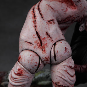 Detailed shot of the Kashimashi statue's lower torso and legs, showing the deep grooves and realistic skin folds of the polystone.