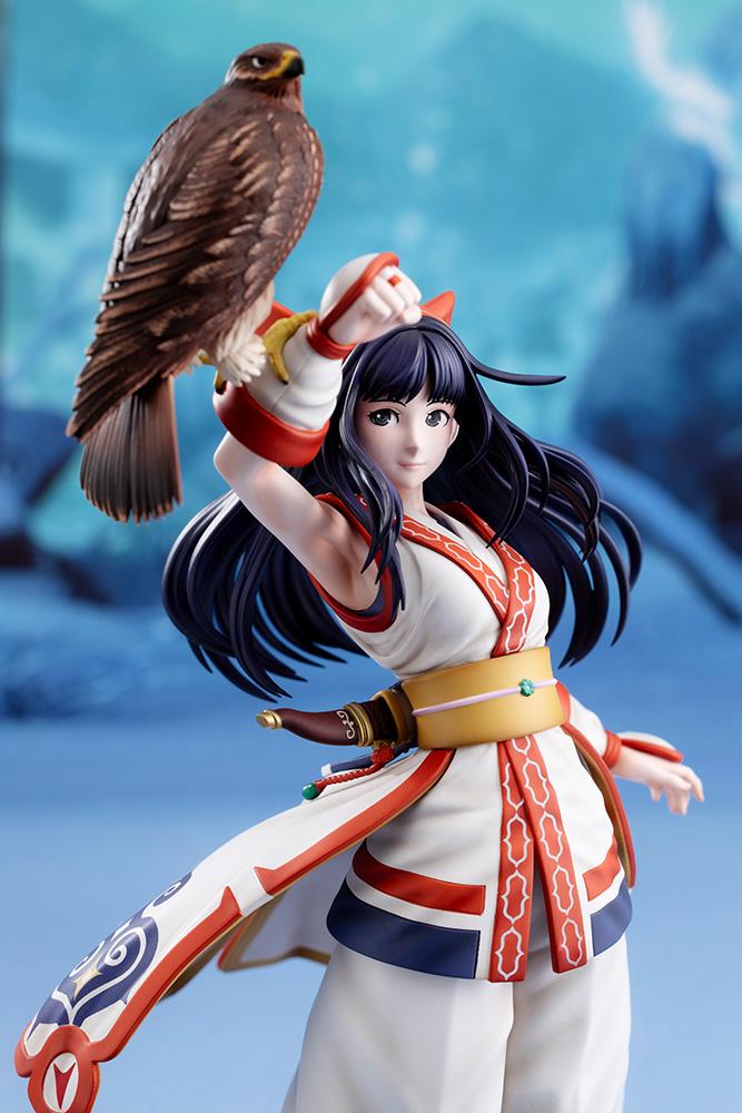 Three-quarter mid-shot of Nakoruru smiling with hawk Mamahaha against a cool blue background