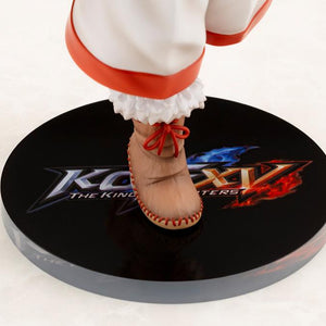 Close-up shot of Nakoruru's fur-trimmed boots and the printed The King of Fighters XV logo display base