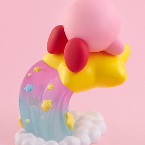 Rear studio view of the Kirby figure highlighting his red feet, round pink shape, and the detailed pastel gradient trail embedded with star graphics.
